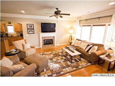 Large living room with tiled gas fireplace.
