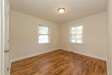 Bedroom 1 with two large windows and refurbished h