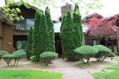 Go between the tall evergreens to the private gate