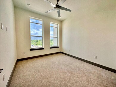 Unfurnished room featuring carpet and ceiling fan