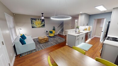 Kitchen with gray cabinetry, light wood-style flo