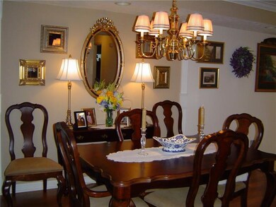 Dining room has a decorative tray ceiling, recesse