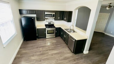 Kitchen with a ceiling fan, a sink, stainless ste