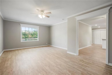 Great Room off of the Kitchen with LVP Flooring, Crown Moulding & Ceiling Fan! 