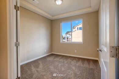 Main floor den/office with coffered ceiling and french doors. This is a general representation of floor plan and may vary from actual home constructed. Features in photos, upgrades, elevation, materials, dimensions and layout all subject to change.