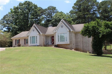 Ranch-style home featuring brick siding, a front lawn, and a chimney