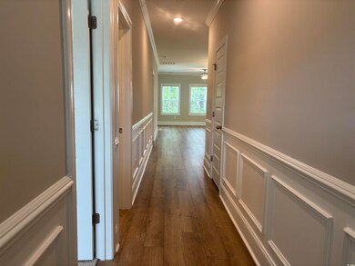 Corridor featuring ornamental molding, a decorativ