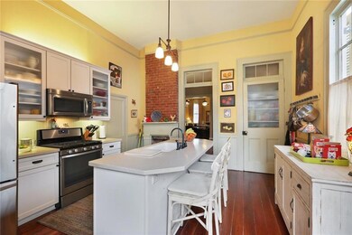 Spacious kitchen with refinished wood floors, appl