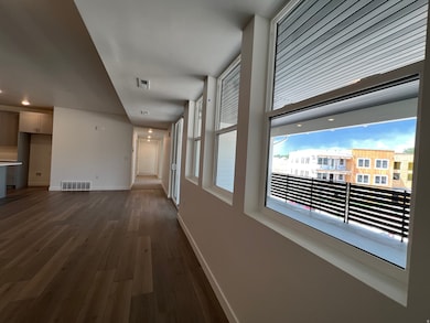 Hallway with dark wood-type flooring and recessed lighting
