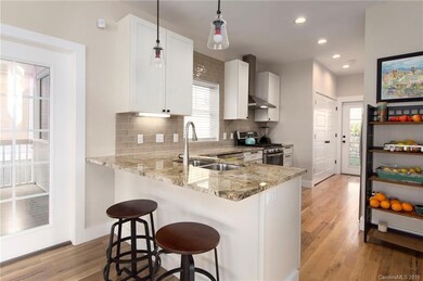 Beautiful Kitchen With Granite Countertops, Breakfast Bar, Recessed and Under Cabinet Lighting, and Five Burner Gas Stove.
