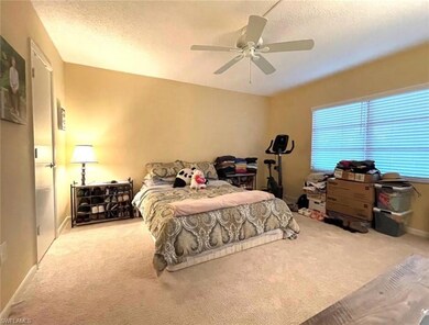 Bedroom with carpet, a textured ceiling, and ceili