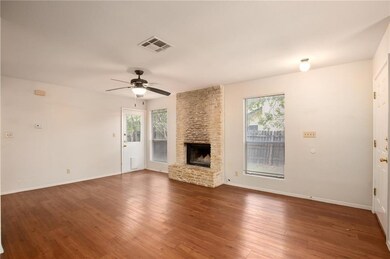 Unfurnished living room featuring a stone firepla