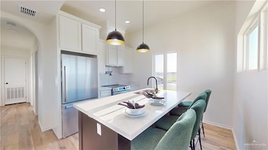 Kitchen with a healthy amount of sunlight, a sink, visible vents, and stainless steel appliances