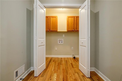Laundry room featuring washer hookup, cabinets, an