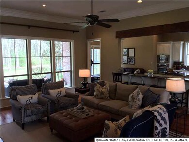Another view of living room and windows overlooking wetlands