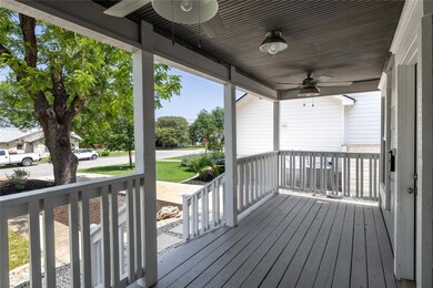Wooden deck with a porch and ceiling fan