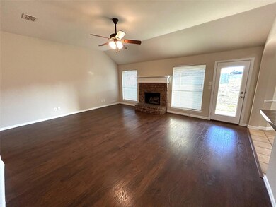 Large Family Room with WB fireplace, view of back yard and wood like flooring