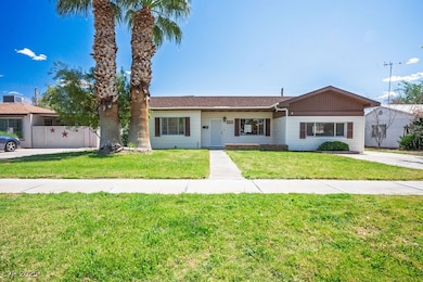 Single story home featuring a front lawn