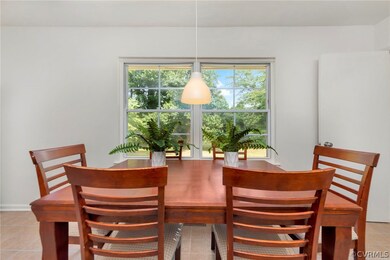 Tiled dining space featuring plenty of natural lig