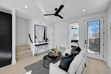 Living room featuring ceiling fan, light wood-typ