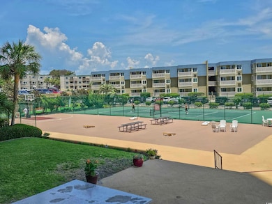 View of community with a tennis court