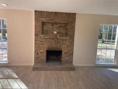 living room with wood burning fireplace.