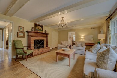 Living room featuring beamed ceiling, ornamental m