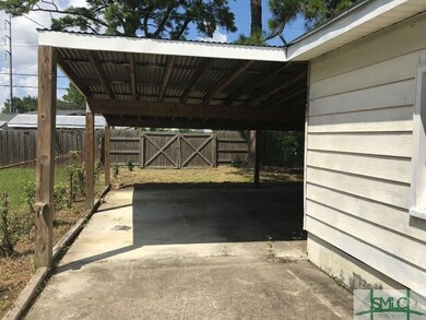 Front Entry to Carport Area.  Double Gate Entry off of  the lane.