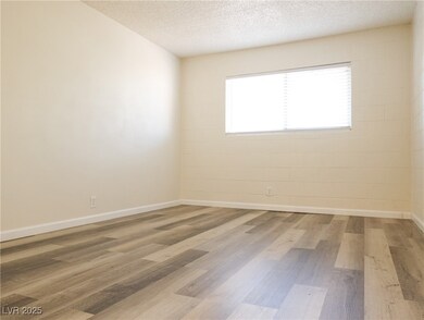 Primary Bedroom w/ NEW LVP flooring + baseboards.