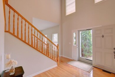 Sunny foyer with hardwood floors.