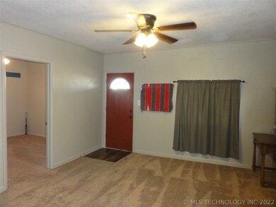 View of the front door, living area and bedroom #1