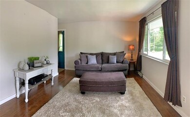 Living room is light & bright with beautiful hardw