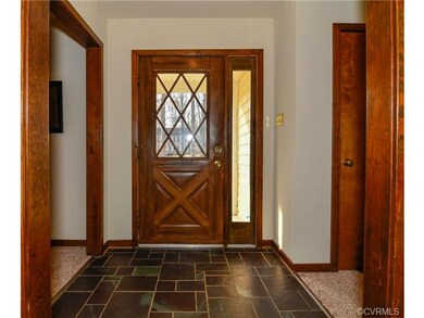 Foyer with slate entrance and real wood door.