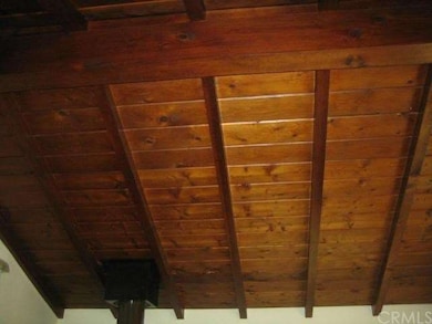 Pitched exposed wood beam ceiling in living room