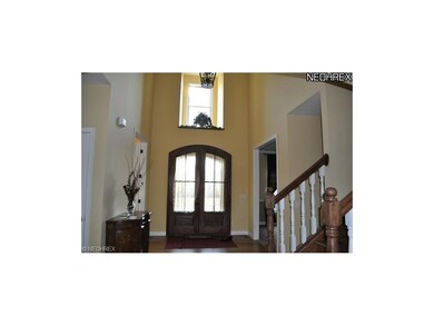 Dramatic Two Story Foyer Has Hardwood Flooring