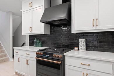 Top-of-the-line gourmet appliances, and a blend of enameled and clear alder cabinets exuding elegance.