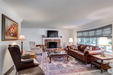Full living room with wall of windows filtering so