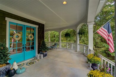 Expansive porch & wooded privacy wraps around prop