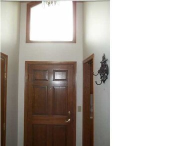 Interior view of front door and transom window ove
