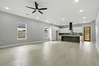 This spacious open-concept living area features mo