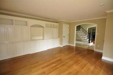 A wall of bookcases highlight the formal living ro