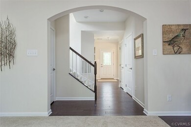 Wide-plank hardwood flooring in foyer, dining room