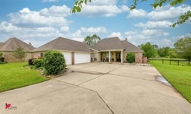 View of front of home with a front lawn and a garage