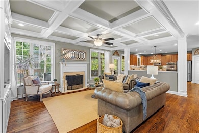 Living room with fireplace and open view to kitchen