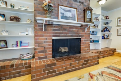 Details featuring a brick fireplace, wood finished