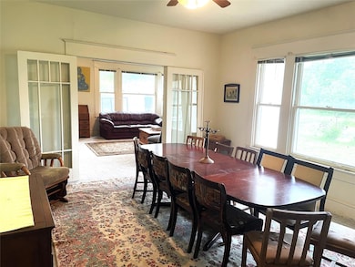 Carpeted dining area with a ceiling fan