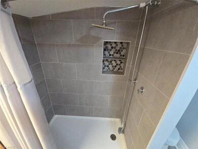 Bathroom featuring a tile shower