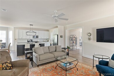 Living room featuring ceiling fan, light hardwood