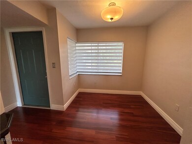 Foyer featuring baseboards and wood finished floor