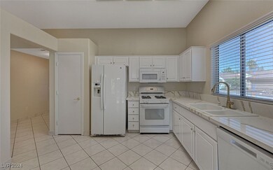 Spacious kitchen with pantry and stone countertops